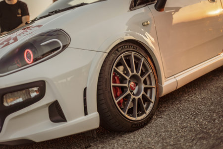 Adria, Italy 30 July 2024: A modified Abarth car showcased at a car meet during sunset.