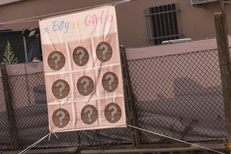 Milan, Italy 29 July 2024: Close-up of a gender reveal game board at a party with colorful decorations and vibrant atmosphere.のeditorial素材