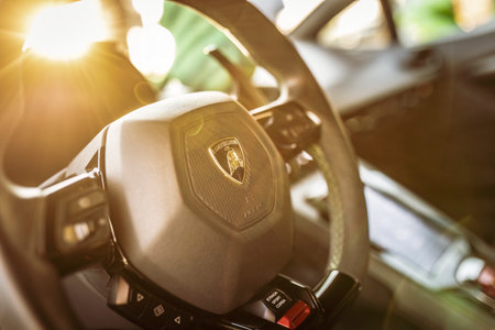 Adria, Italy 30 July 2024: Detailed shot of a Lamborghini steering wheel with the logo in focusのeditorial素材