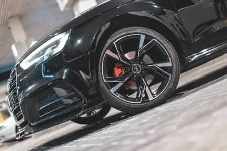 Adria, Italy 30 July 2024: Sleek black Audi A3 parked at a gas station during nighttime with modern design and stylish rimsのeditorial素材