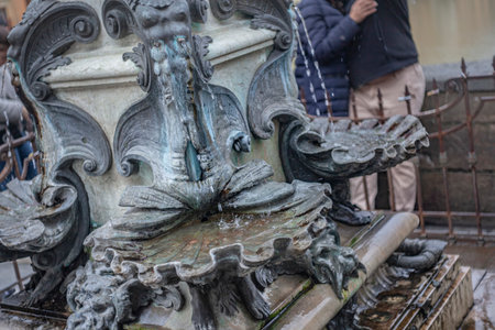 Florence, Italy 1 January 2025: Water pouring from a fountain featuring mythological figures in florence, italyの写真素材