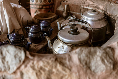 Metal kettles and teapots sit on a traditional oven in the desert of Marsa Alam, Egypt, showcasing a...