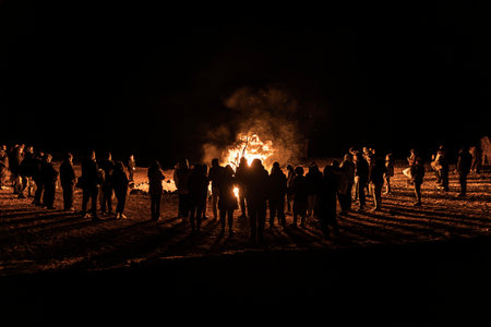 Tourists enjoying a bonfire in the Marsa Alam desert at night, creating a captivating scene of warmth and community against the dark backdropの写真素材