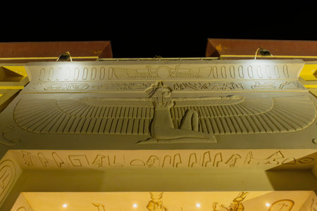 Goddess nuit spreading her wings over hieroglyphs and ancient Egyptian figures, illuminated at...