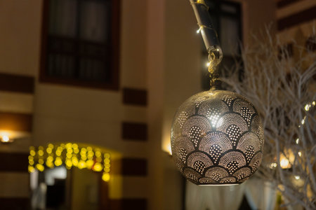 Beautiful metal lantern casting warm light in port ghalib, egypt, creating a magical ambiance at nightの写真素材