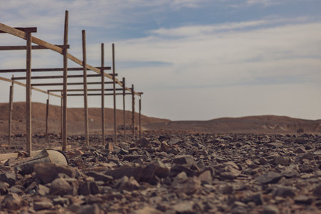 Wooden frame decaying in the arid landscape of Marsa Alam desert, showing the impact of time and elementsの写真素材
