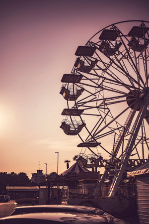 Chioggia, Italy 21 June 2025, ferris wheel and carousel at sunset in an amusement park in Chioggia, Italyの写真素材