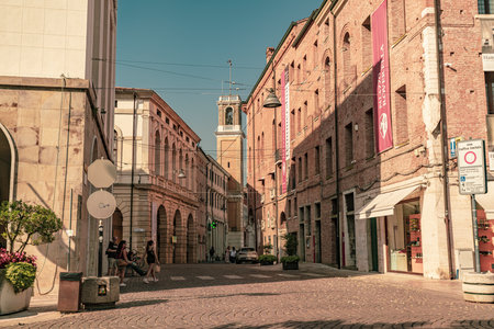 Rovigo, Italy 21 June 2025, street view in Rovigo, Italy, featuring tourists walking in the city center near the tower of Palazzo della Roverellaの写真素材