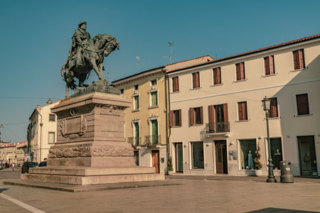 Rovigo, Italy June 21, 2025, Bronze Garibaldi statue on horseback overlooking Piazza Vittorio Emanuele II in Rovigo, Italy, surrounded by traditional buildingsの写真素材
