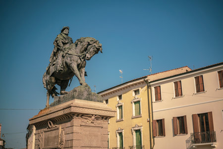 Rovigo, Italy June 21, 2025, Bronze statue of Giuseppe Garibaldi riding a horse in Piazza Garibaldi, Rovigo, Italy, with historic buildings in the backgroundの写真素材