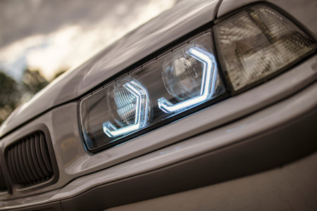 Close up of illuminated led headlights on a tuned sports car, highlighting automotive lighting...