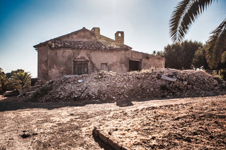 Crumbling abandoned house in Falconara, Sicily, stands as a testament to time and decay, highlighting neglect and the transient nature of human structuresの写真素材