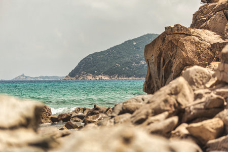 Scenic view of the turquoise Mediterranean sea from a rocky coastline in Monte Turnu, Italy, showcasing the natural beauty of the Italian coastの写真素材