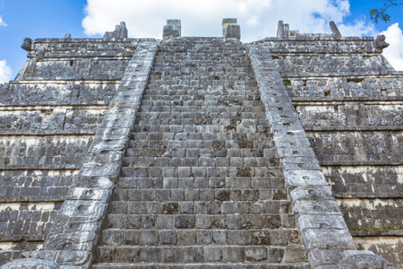 Stone steps ascending a Mayan pyramid at Chichen Itza, an ancient city in Mexico, showcasing...