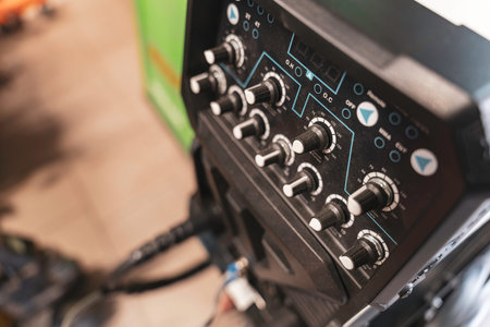Rovigo, Italy 18 December 2025: industrial welding machine control panel with numerous dials and buttons for adjusting parameters and settings in a workshopのeditorial素材