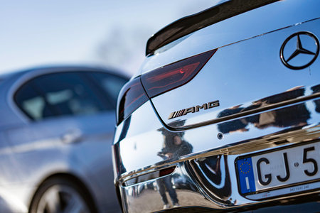 Imola, italy 01 january 2026: mercedes-benz amg coupe in chrome finish reflecting blue sky,...