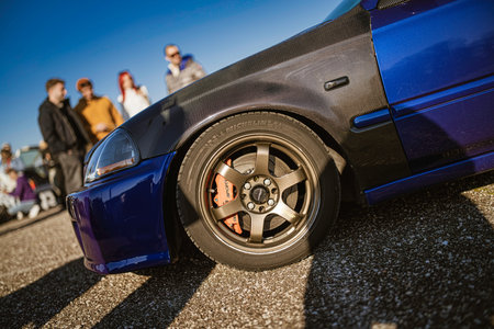 Imola, italy 01 january 2026: blue performance car showcasing custom parts like carbon fiber...