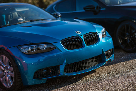 Imola, italy 01 january 2026: blue bmw high-performance sports car parked outdoors under sunlight,...