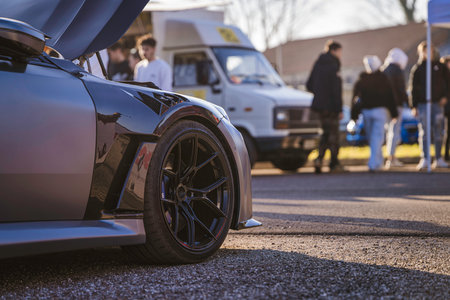 Imola, italy 01 january 2026: custom-tuned sports car side view with detailed wheel and bodywork at...