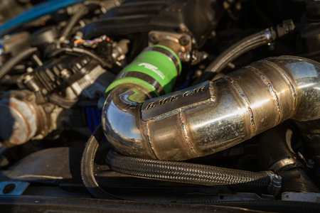 Imola, italy 01 january 2026: aftermarket exhaust manifold with tig-welded seams, polished metal...
