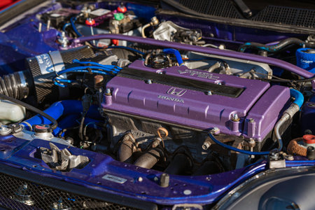 Imola, italy 01 january 2026: custom-built performance honda engine bay with purple vtec valve cover, blue silicone hoses and polished chrome components, close-up detailのeditorial素材