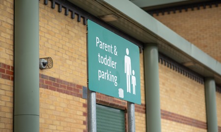 A parent and toddler parking sign at a large supermarketの写真素材