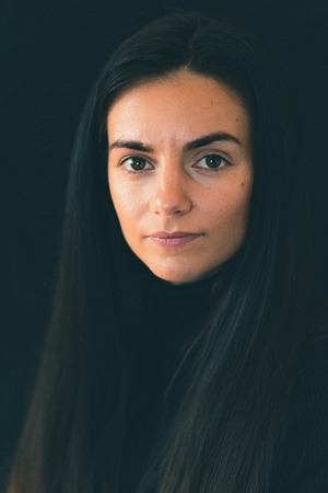 A young female caucasian smiles at the cameraの写真素材