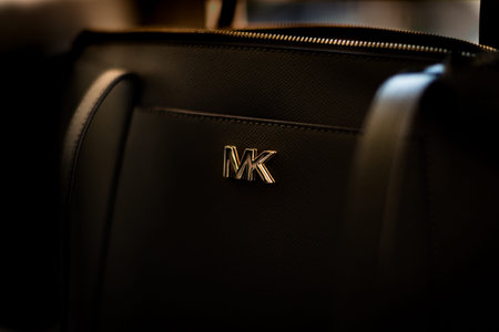 Isolated close up of a black Michael Kors handbagand logo
