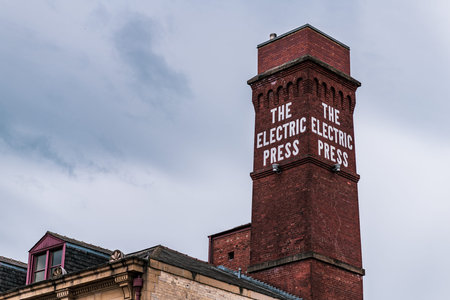 LEEDS, UK - 1ST JUNE 2019: The Electric Press famous chimney and sign on display in the city