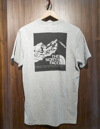 SHEFFIELD, UK - 2ND JUNE 2019: A North Face t-shirt with a graphic on the front on display in a store in Meadowhall, South Yorkshire, UKのeditorial素材