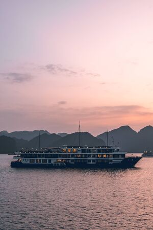 Ha Long Bay in Vietnam during a beautiful Sunset with calm, tranquil seas. Shot in Autumn 2019 from a cruise ship tourの写真素材