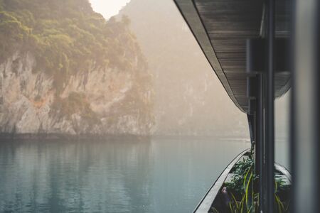 Ha Long Bay in Vietnam during a beautiful Sunset with calm, tranquil seas. Shot in Autumn 2019 from a cruise ship tourの写真素材