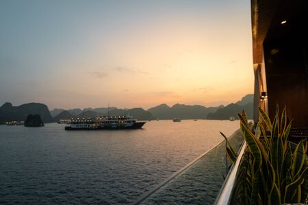 Ha Long Bay in Vietnam during a beautiful Sunset with calm, tranquil seas. Shot in Autumn 2019 from a cruise ship tourの写真素材
