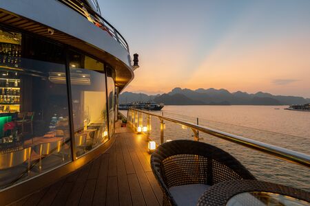 5 Star luxury on new modern Cruise Ships on Ha Long Bay, Vietnam looking over the stunning limestone rocks at Sunsetの写真素材