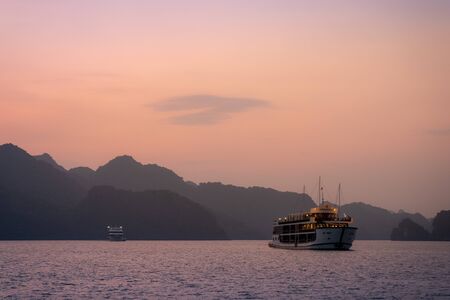 Ha Long Bay in Vietnam during a beautiful Sunset with calm, tranquil seas. Shot in Autumn 2019 from a cruise ship tourの写真素材
