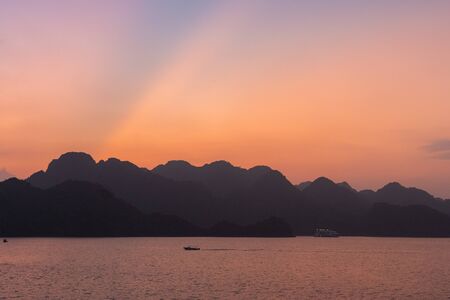 Ha Long Bay in Vietnam during a beautiful Sunset with calm, tranquil seas. Shot in Autumn 2019 from a cruise ship tourの写真素材