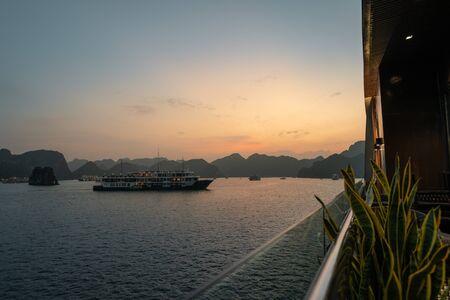Ha Long Bay in Vietnam during a beautiful Sunset with calm, tranquil seas. Shot in Autumn 2019 from a cruise ship tourの写真素材