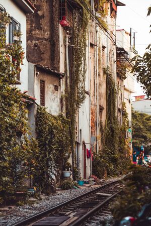 Brightly lit beautiful houses down the narrow and dangerous Train Street in Hanoi, Vietnamの写真素材