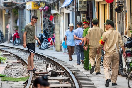 Hanoi, Vietnam - 18th October 2019: Police guards patrol the famous Train Street after it was closed off to the public due to accidentsのeditorial素材
