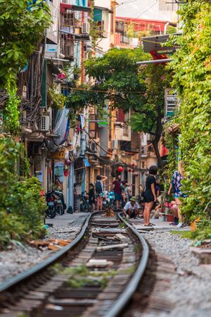 Hanoi, Vietnam - 18th October 2019: Tourists take photos whilst standing on the tracks at Train Street in Hanoi, Vietnamのeditorial素材