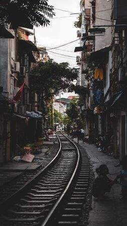 A dark and moody shot down the railway lines of the famous Train Street in North Vietnamの写真素材