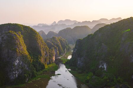 Beautiful sunset over Vietnamese rivers and Landscape from the scenic Mua Caves and Dragon Statue in Tam Coc, Ninh Binh, Vietnamの写真素材