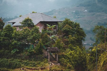 Houses and homes on top of Rice terraces outside the beautiful village of Sapa in Northern Vietnam, surrounded by mountainsの写真素材
