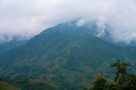 Beautiful landscape images of Sapa and the surrounding mountains with their peaks poking out of cloudsの写真素材