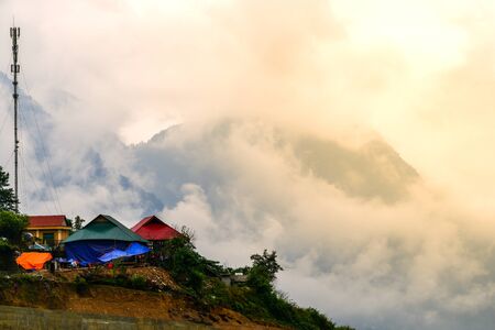 Beautiful landscape images of Sapa at sunrise and the surrounding mountains with their peaks poking out of cloudsの写真素材