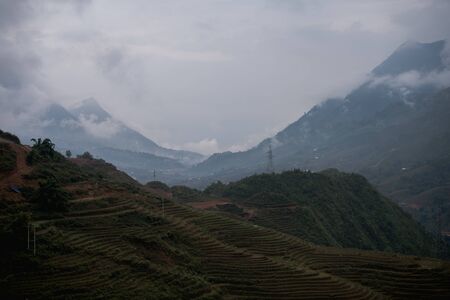Beautiful landscape images of Sapa and the surrounding mountains with their peaks poking out of cloudsの写真素材