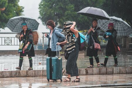 Sapa, Vietnam - 13th October 2019: Local woman of the small mountain town in North Vietnam who sell tours to passing touristsのeditorial素材
