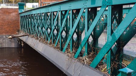 Aftermath of the River Don flooding in Sheffield, November 2019. Bridges clogged up with sticks and debris show the height of the water level during the floodの写真素材