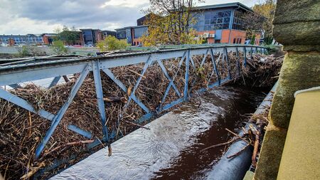 Aftermath of the River Don flooding in Sheffield, November 2019. Bridges clogged up with sticks and debris show the height of the water level during the floodの写真素材