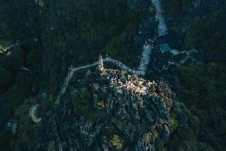 Aerial drone sunset photo of the top of Hang Mua mountains with the famous dragon statues and pagodaの写真素材